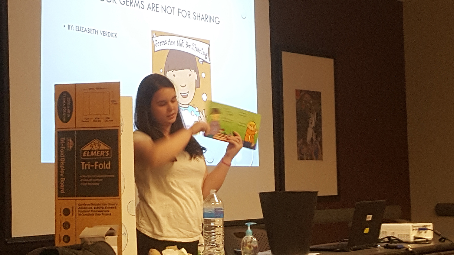 Natalie Gill is showing a book that you could read to preschoolers to teach about handwashing during her health visual